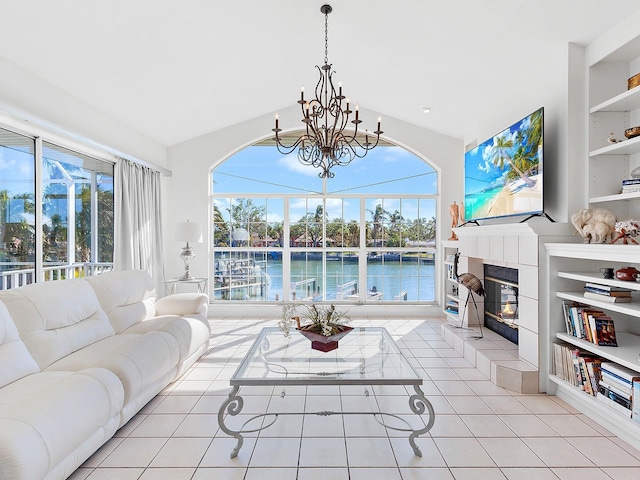 508 Siesta Dr, Sarasota, FL 34242 - living room featuring a fireplace, a chandelier, tile patterned flooring, and built in shelves