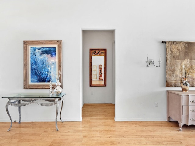 corridor with light hardwood / wood-style flooring