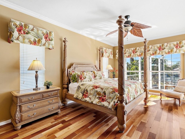 bedroom with ceiling fan, light hardwood / wood-style floors, and ornamental molding