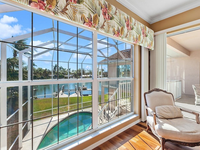 sunroom featuring a water view