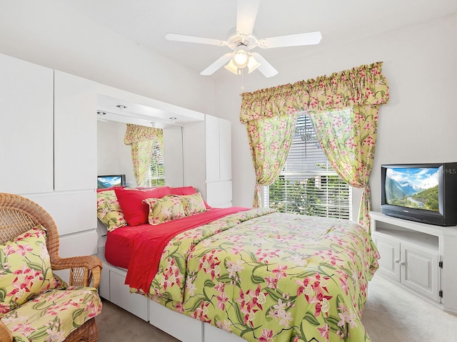 bedroom with ceiling fan and light colored carpet