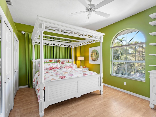 bedroom with light hardwood / wood-style flooring and ceiling fan