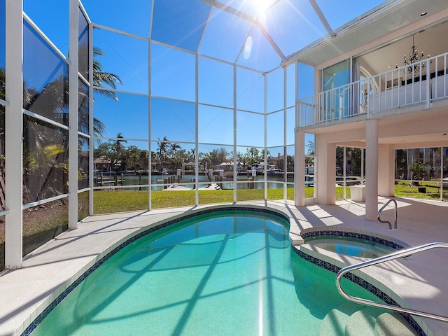 view of swimming pool with an in ground hot tub, a water view, glass enclosure, and a patio area