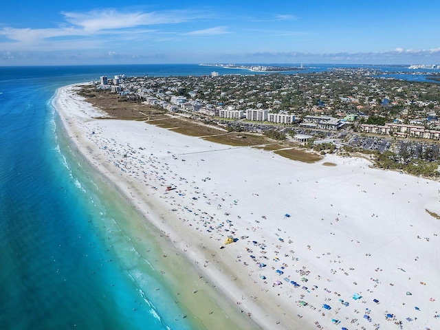 birds eye view of property featuring a view of the beach and a water view