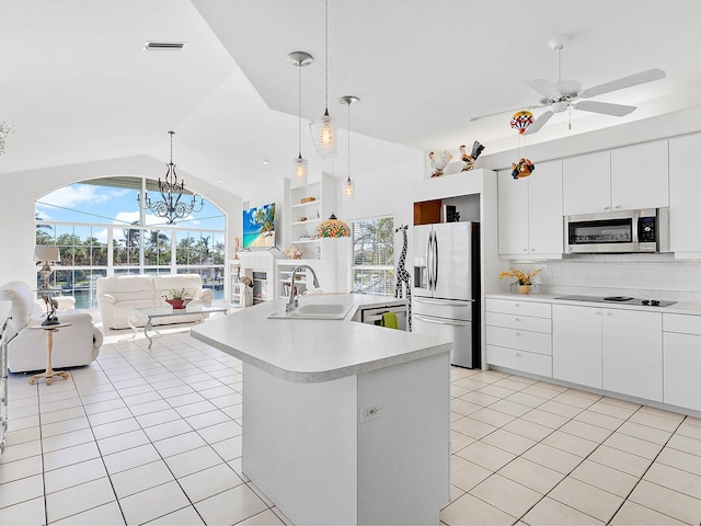 508 Siesta Dr, Sarasota, FL 34242 - kitchen featuring stainless steel appliances, open floor plan, light tile patterned flooring, light countertops, and tasteful backsplash