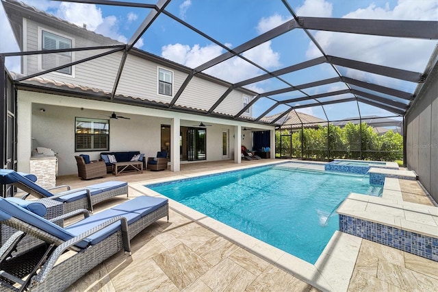 view of pool with outdoor lounge area, glass enclosure, pool water feature, an in ground hot tub, and a patio