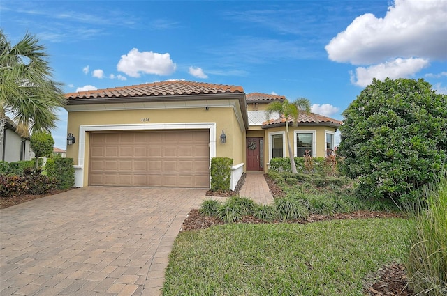 mediterranean / spanish home featuring a garage