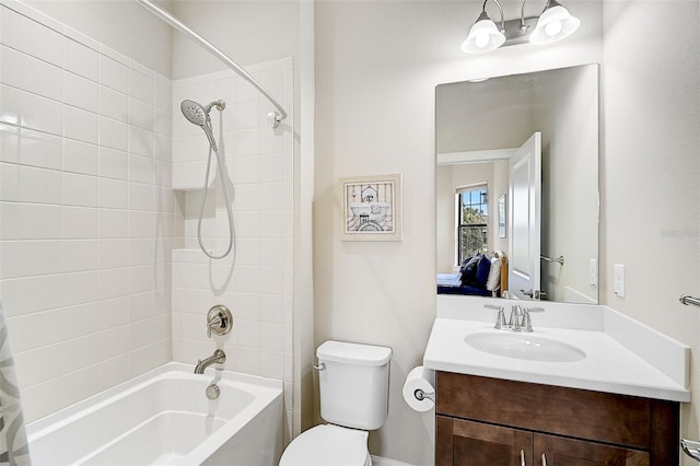 full bathroom featuring vanity, toilet, and tiled shower / bath