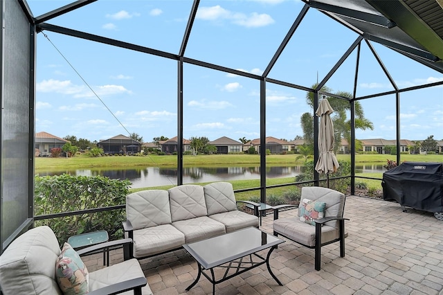 view of patio with outdoor lounge area, a water view, area for grilling, and a lanai