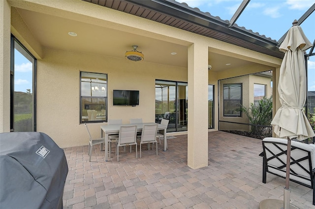 view of patio with a lanai and grilling area