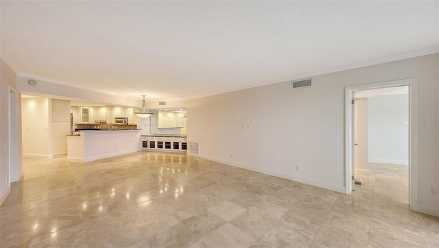 unfurnished living room with crown molding, visible vents, and baseboards