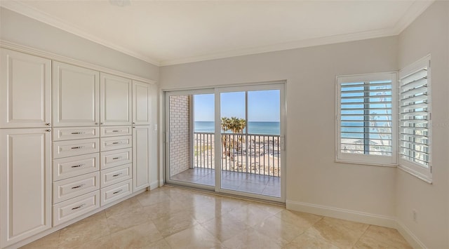 interior space with crown molding, access to outside, a water view, and baseboards