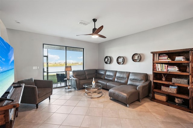 living room featuring ceiling fan and light tile patterned floors