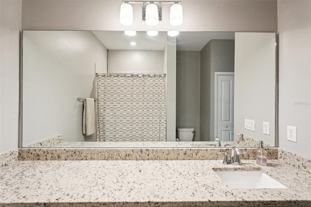 bathroom with vanity and toilet