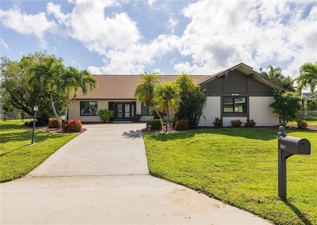 ranch-style house featuring french doors and a front yard