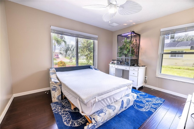 bedroom with multiple windows, ceiling fan, and dark hardwood / wood-style floors