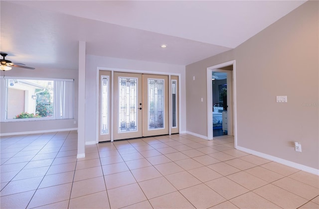 entryway with french doors, light tile patterned floors, and ceiling fan