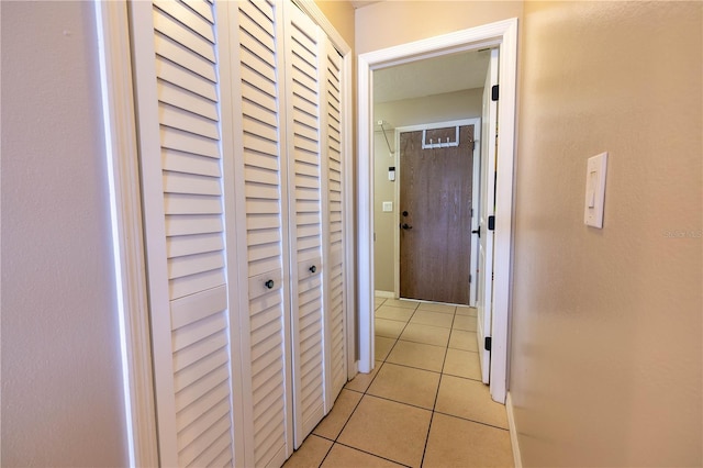 hall with light tile patterned floors