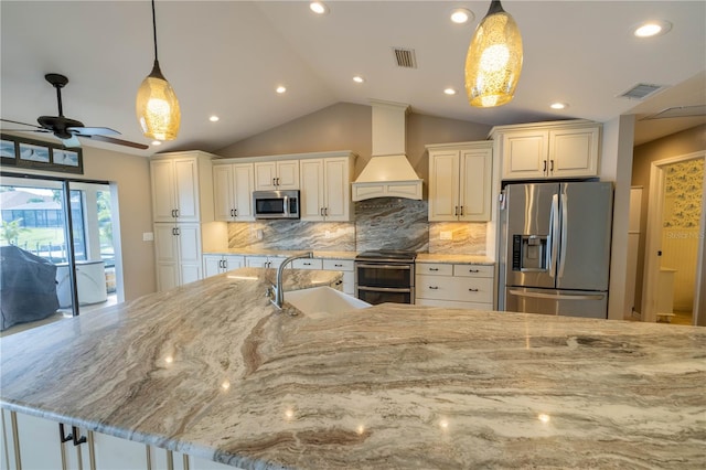 kitchen featuring sink, stainless steel appliances, light stone counters, decorative light fixtures, and custom exhaust hood