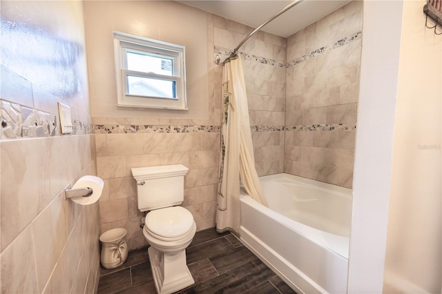 bathroom with shower / bath combination with curtain, toilet, tile walls, and hardwood / wood-style floors