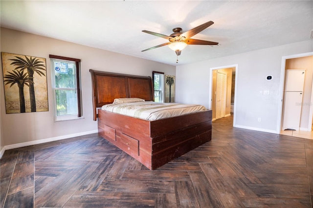 bedroom with ceiling fan and dark parquet flooring