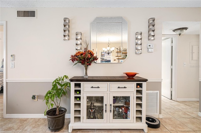 interior space with light tile patterned flooring, white cabinetry, and a textured ceiling