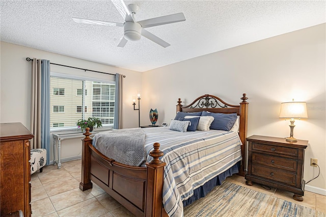 tiled bedroom with ceiling fan and a textured ceiling