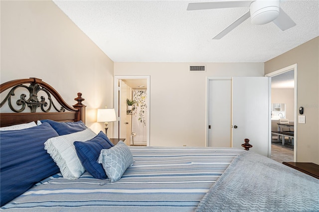 bedroom with connected bathroom, ceiling fan, a closet, and a textured ceiling