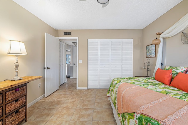 tiled bedroom featuring a textured ceiling