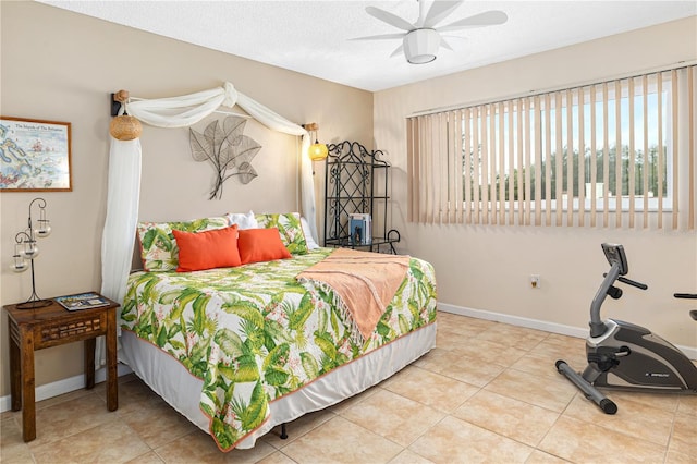 bedroom with a textured ceiling, tile patterned floors, and ceiling fan