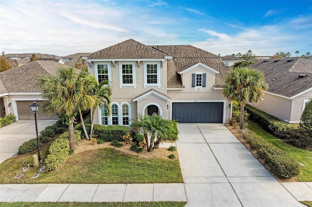 view of front of property with a garage and a front lawn