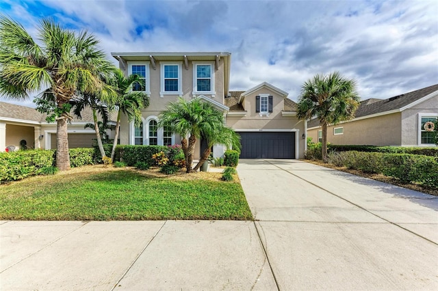 view of front of home featuring a front yard and a garage