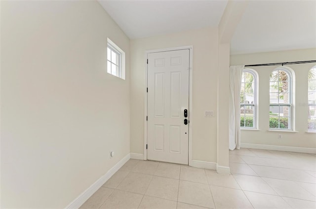 foyer featuring light tile patterned floors and a healthy amount of sunlight