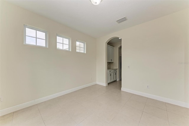 spare room with light tile patterned floors