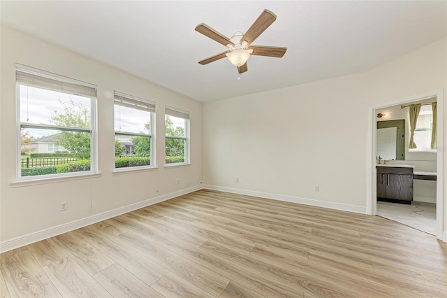 spare room featuring ceiling fan and light hardwood / wood-style floors