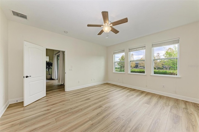 unfurnished room with light hardwood / wood-style flooring, ceiling fan, and a healthy amount of sunlight