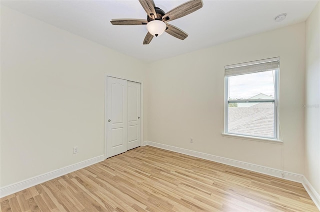 spare room with ceiling fan and light wood-type flooring