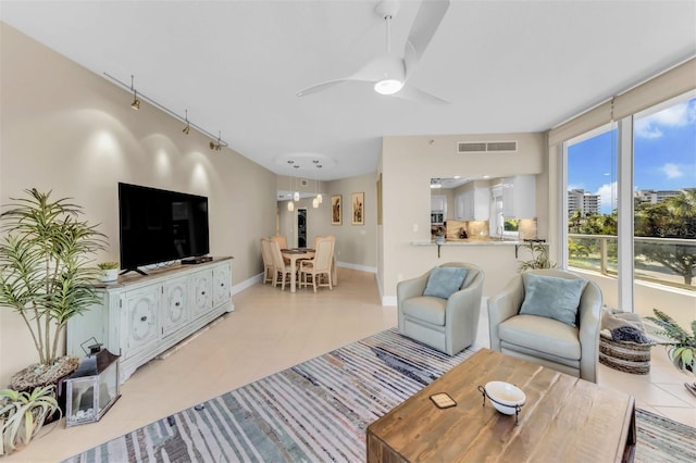 tiled living room with ceiling fan