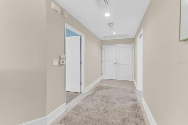 hall featuring light tile patterned floors