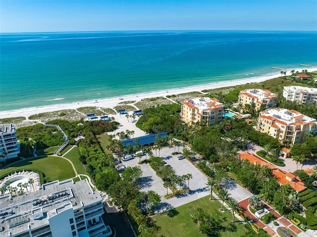 birds eye view of property with a water view and a view of the beach