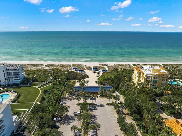 birds eye view of property with a water view and a view of the beach