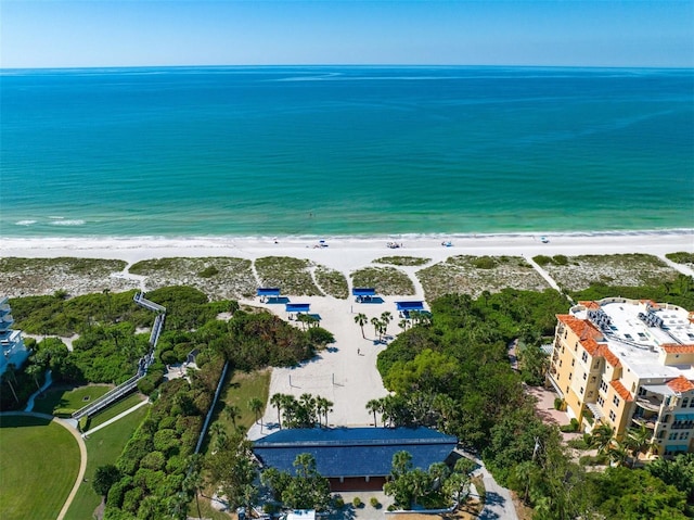 bird's eye view featuring a water view and a beach view