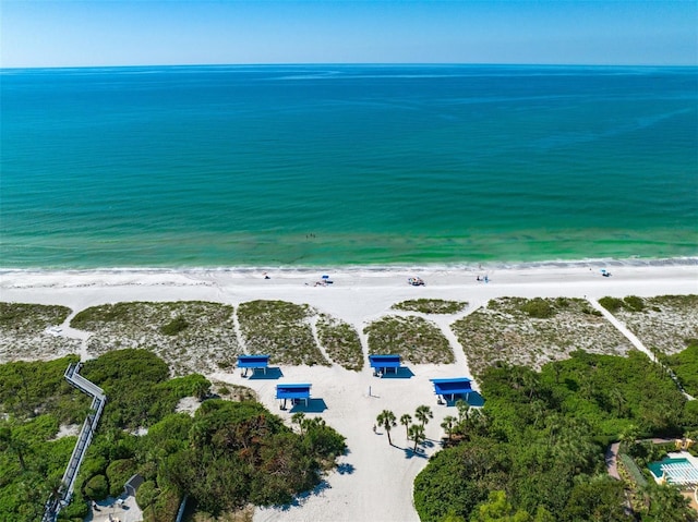 birds eye view of property featuring a view of the beach and a water view