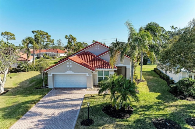 mediterranean / spanish-style home featuring a garage and a front yard