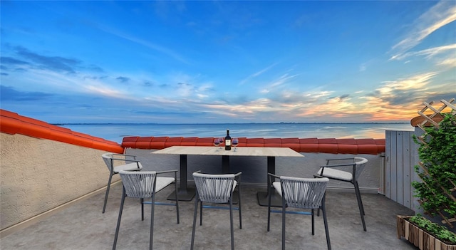 patio terrace at dusk with a water view