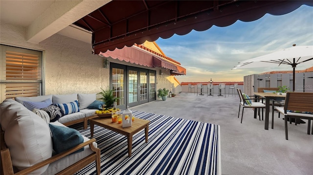 patio terrace at dusk featuring outdoor lounge area