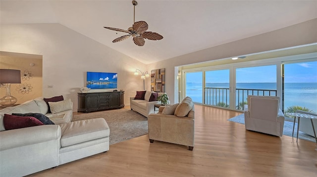 living room with light hardwood / wood-style floors, high vaulted ceiling, and ceiling fan