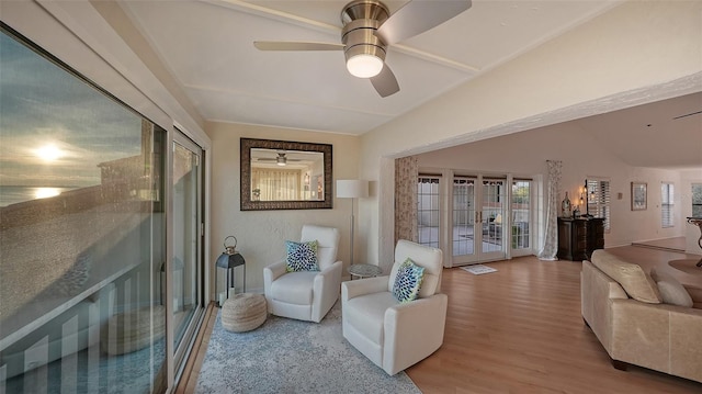 living room with french doors, ceiling fan, lofted ceiling, and hardwood / wood-style flooring