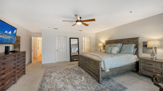 bedroom with a textured ceiling and ceiling fan