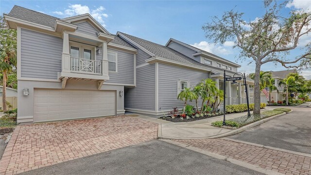 view of front of home with a balcony and a garage